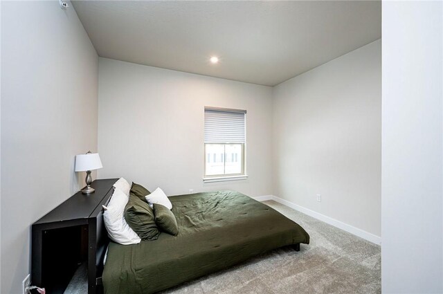 bedroom featuring light colored carpet