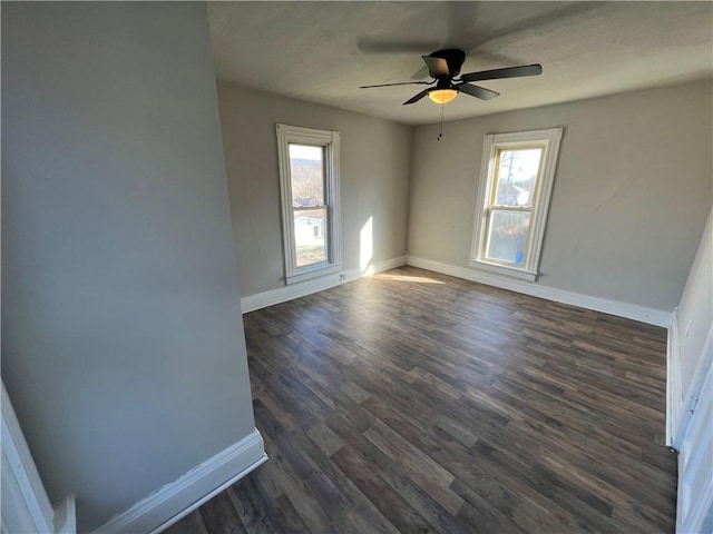 spare room with dark wood-type flooring and ceiling fan