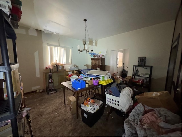 dining space featuring an inviting chandelier and carpet flooring