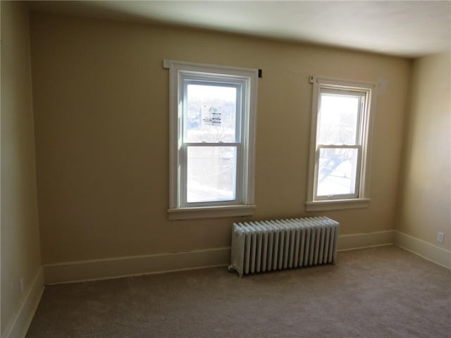 carpeted empty room with radiator