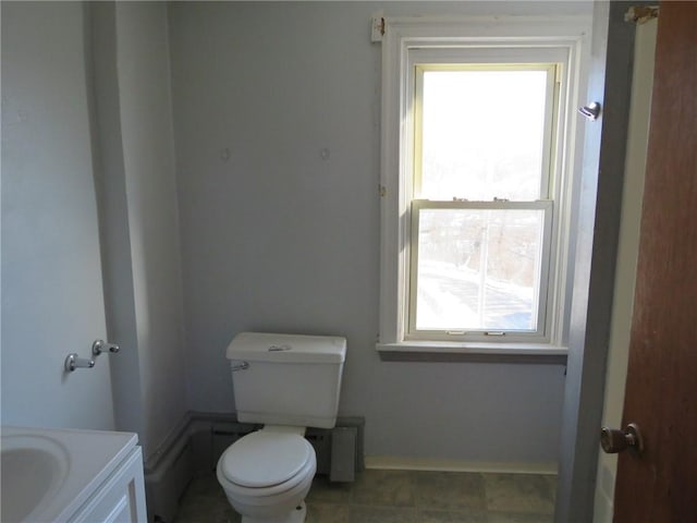 bathroom featuring vanity, plenty of natural light, and toilet