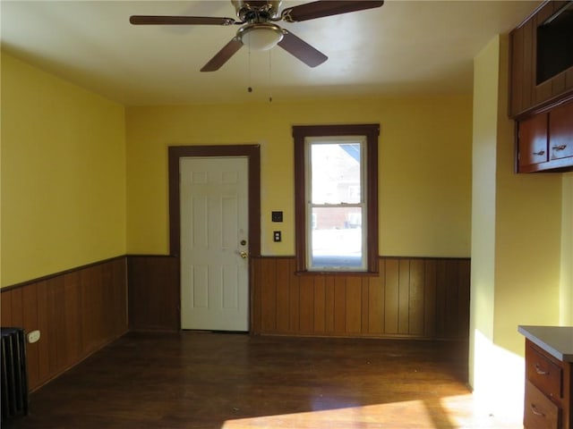 foyer featuring ceiling fan, radiator, and dark hardwood / wood-style flooring