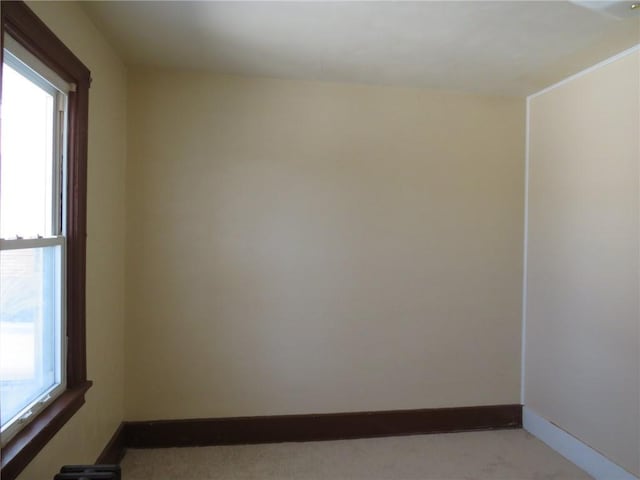 empty room with a wealth of natural light and light colored carpet