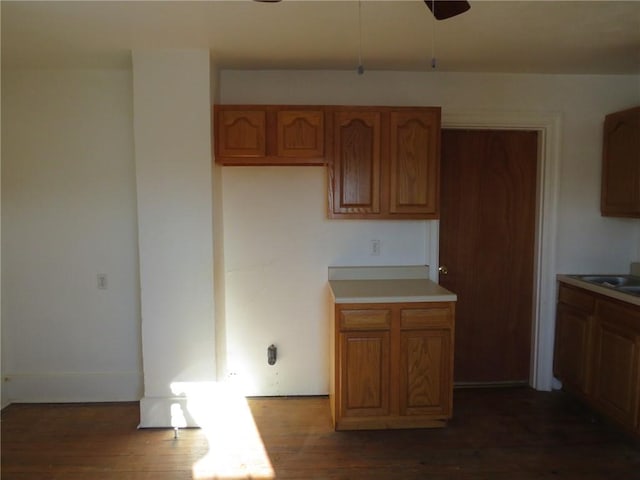 kitchen with dark wood-type flooring and ceiling fan