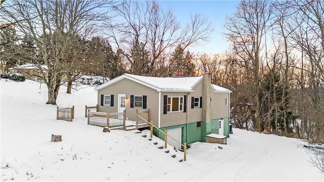 view of front of property with a garage and a deck