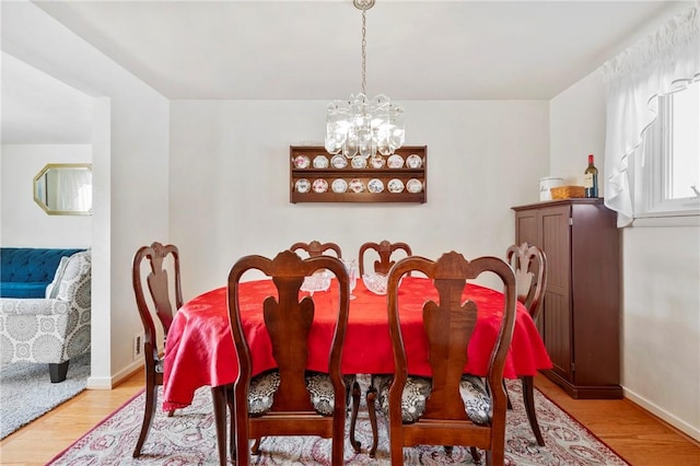 dining room featuring a notable chandelier and light hardwood / wood-style floors