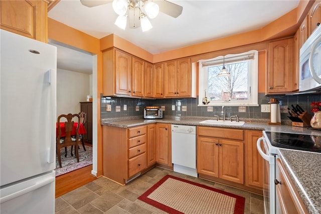 kitchen with sink, white appliances, decorative backsplash, and ceiling fan