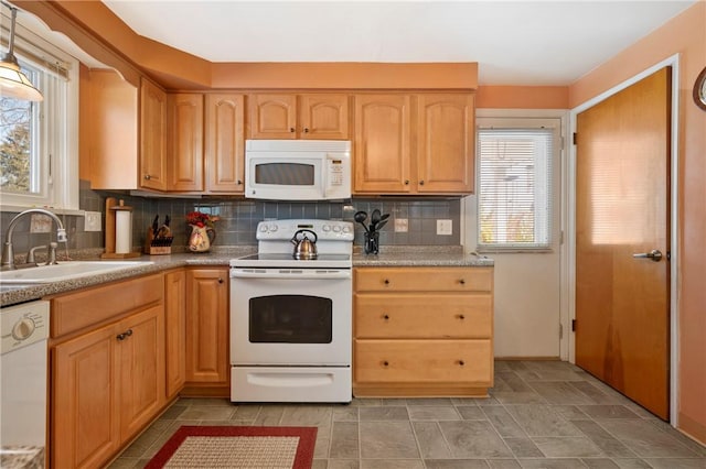 kitchen with light brown cabinetry, sink, white appliances, and decorative backsplash