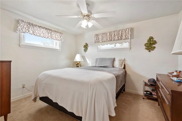 bedroom featuring light colored carpet and ceiling fan