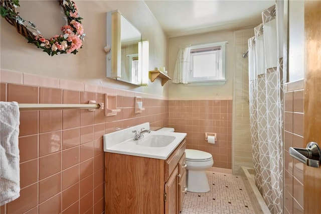 bathroom with a shower with curtain, vanity, tile patterned flooring, and tile walls