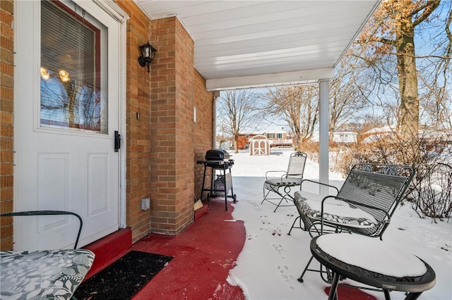 snow covered patio with grilling area