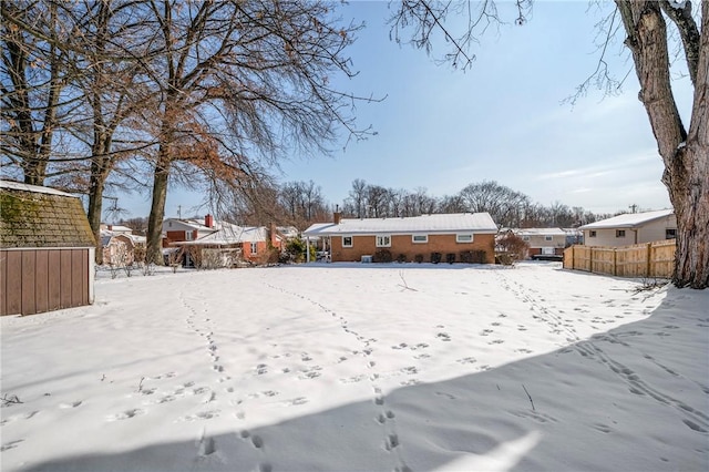 snowy yard with a storage unit