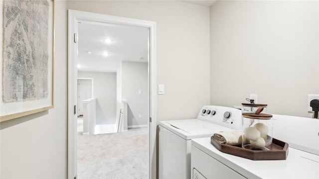 laundry area with light carpet and washer and clothes dryer