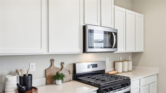 kitchen with white cabinets and appliances with stainless steel finishes