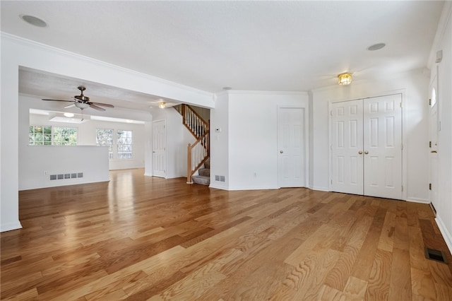 unfurnished living room featuring crown molding and light hardwood / wood-style floors