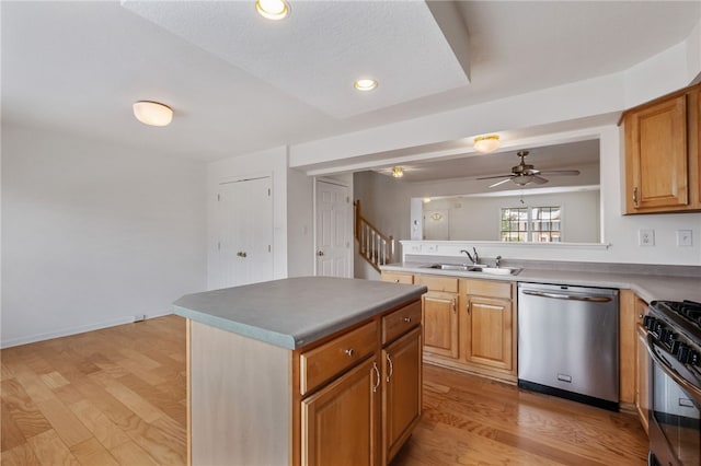 kitchen with dishwasher, sink, a center island, gas stove, and light hardwood / wood-style flooring