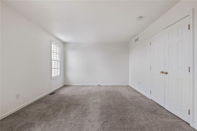 empty room featuring carpet flooring