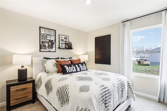 carpeted bedroom featuring multiple windows