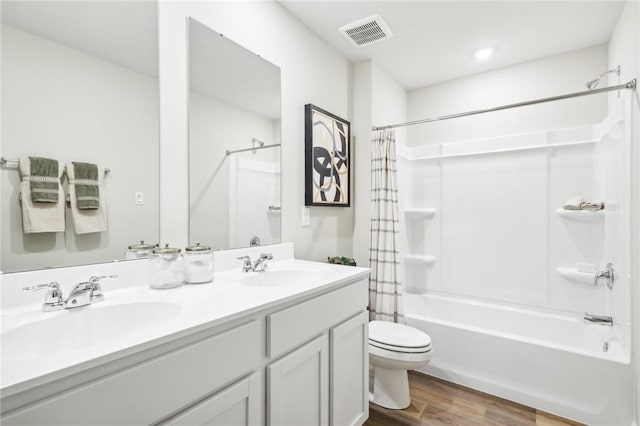 full bathroom with shower / tub combo with curtain, vanity, toilet, and hardwood / wood-style floors