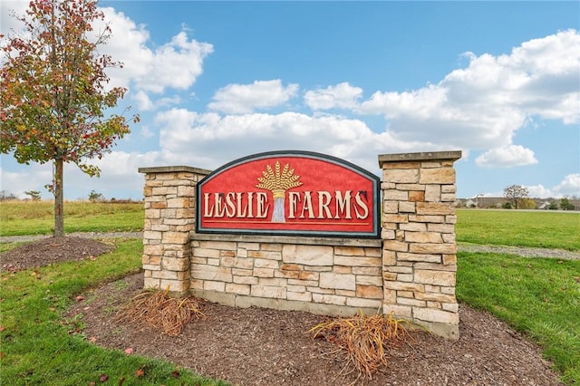 community sign featuring a lawn