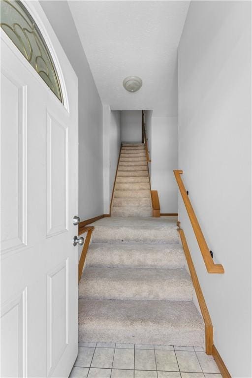 stairs with tile patterned flooring