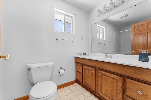 bathroom featuring a shower, vanity, tile patterned floors, and toilet