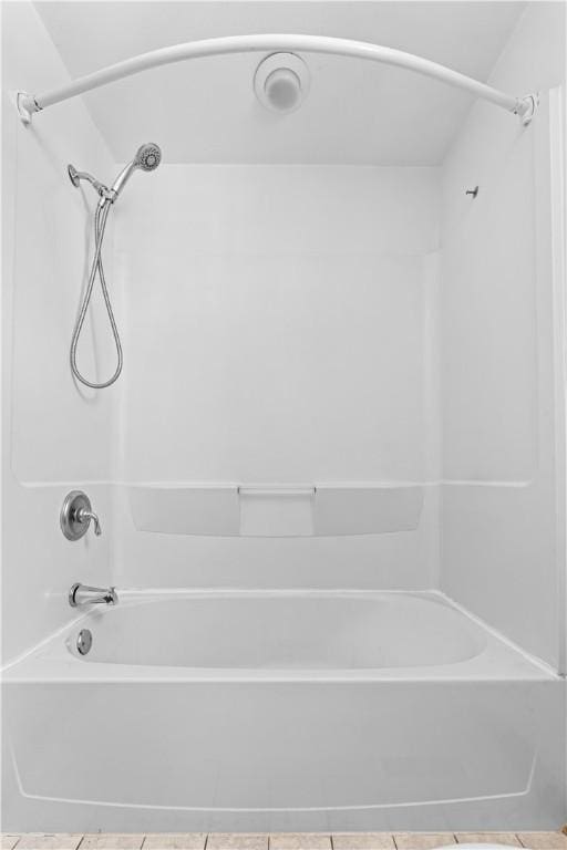 bathroom featuring tile patterned flooring and shower / bathing tub combination