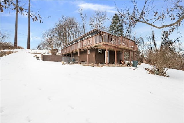 snow covered property featuring a deck