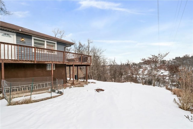 yard covered in snow with a wooden deck