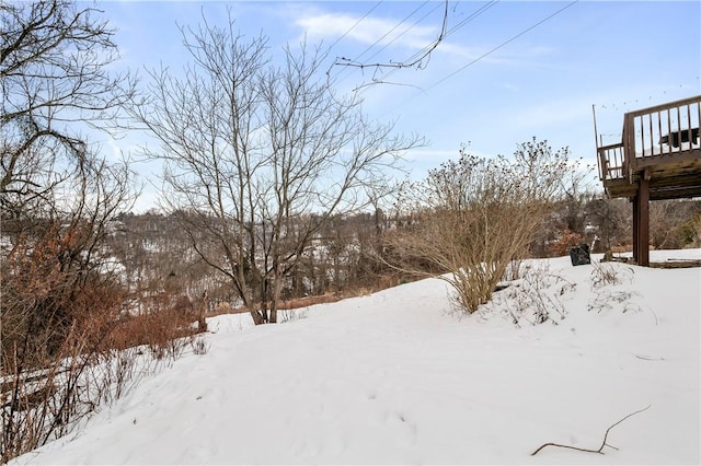 yard covered in snow with a wooden deck