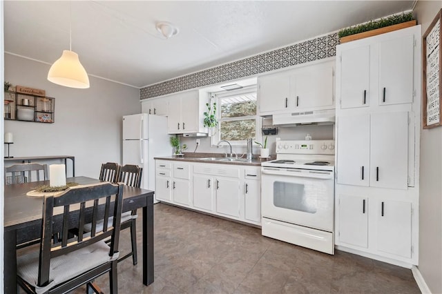 kitchen with hanging light fixtures, sink, white cabinets, and white appliances