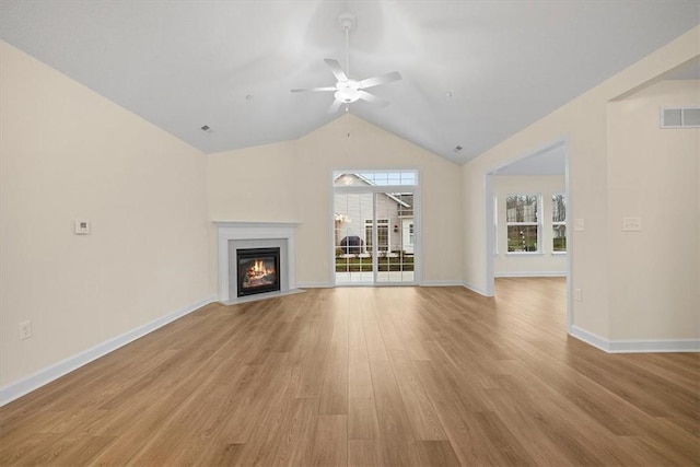 unfurnished living room featuring light hardwood / wood-style flooring, vaulted ceiling, and ceiling fan