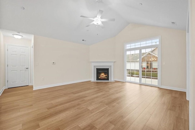 unfurnished living room with ceiling fan, vaulted ceiling, and light wood-type flooring