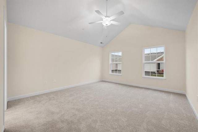 unfurnished room with vaulted ceiling, light colored carpet, and ceiling fan