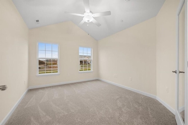 carpeted empty room featuring ceiling fan and vaulted ceiling