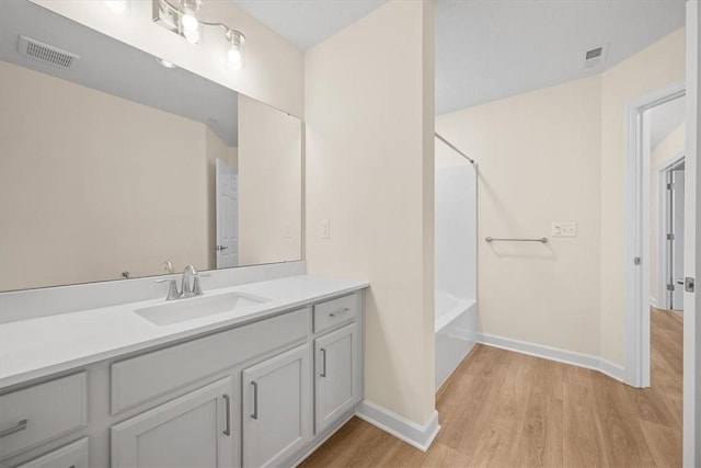 bathroom featuring vanity, hardwood / wood-style floors, and independent shower and bath