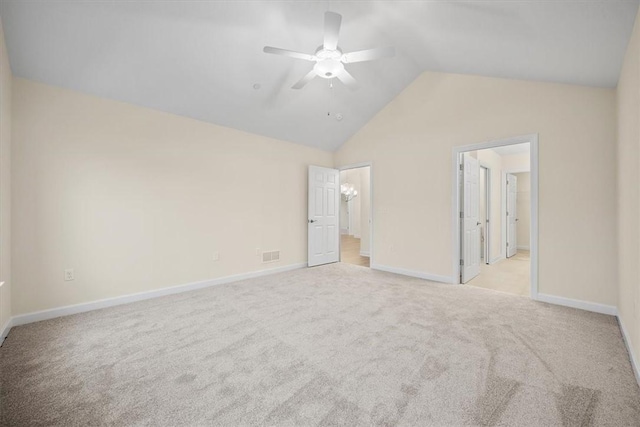 unfurnished bedroom featuring lofted ceiling, light carpet, and ceiling fan