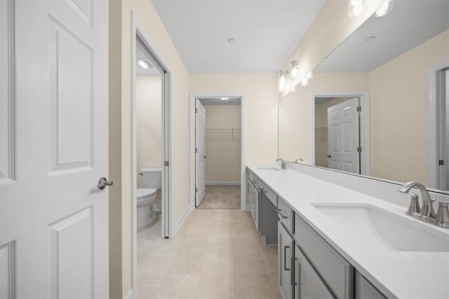 bathroom featuring vanity, tile patterned flooring, and toilet