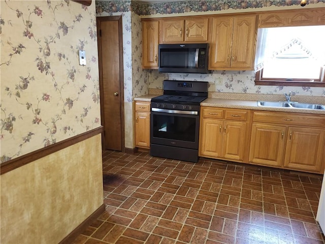 kitchen with range with gas stovetop and sink