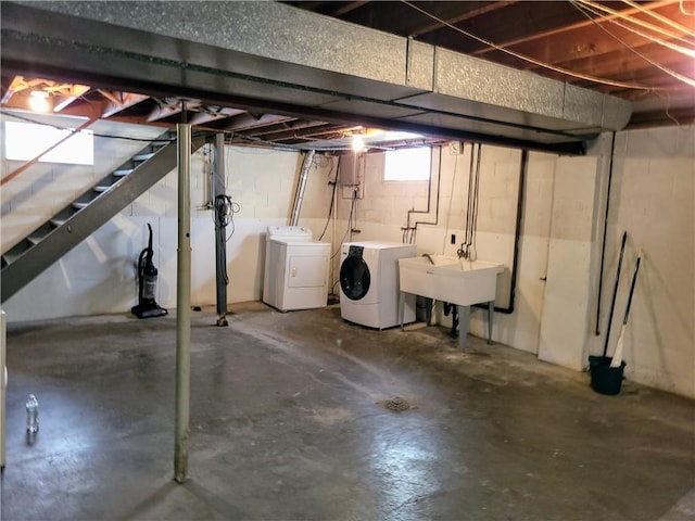 basement with separate washer and dryer and sink