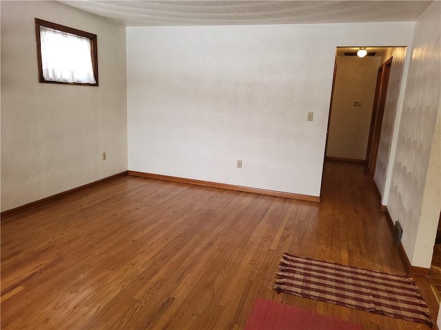 empty room featuring dark wood-type flooring