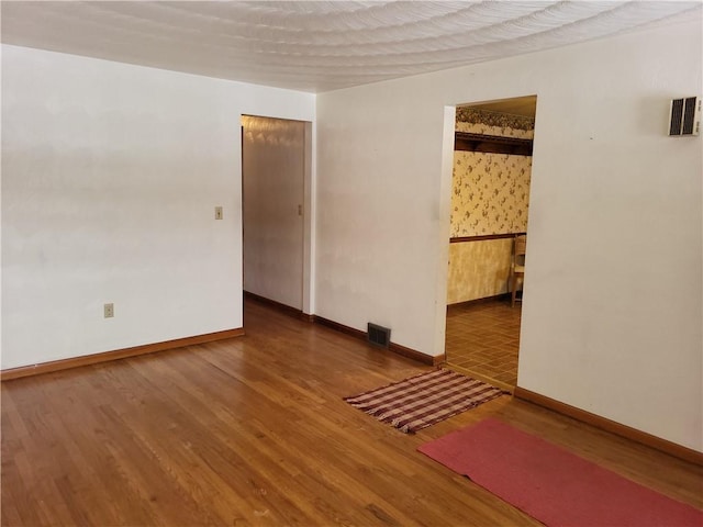 unfurnished room featuring hardwood / wood-style flooring