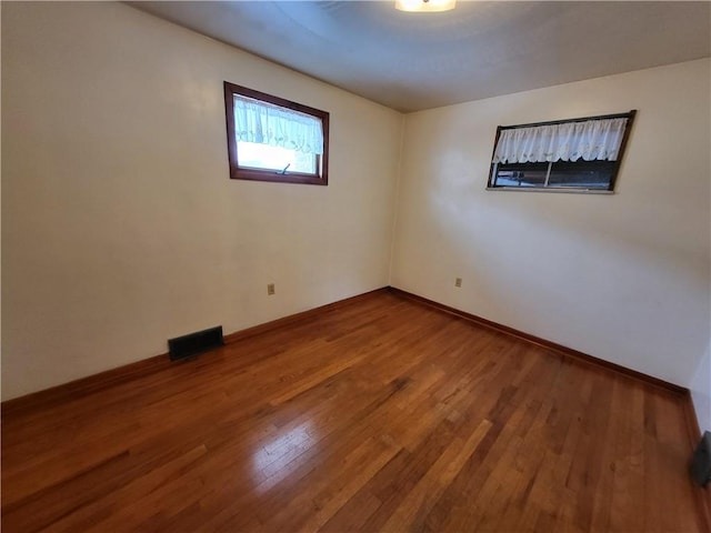 spare room featuring wood-type flooring