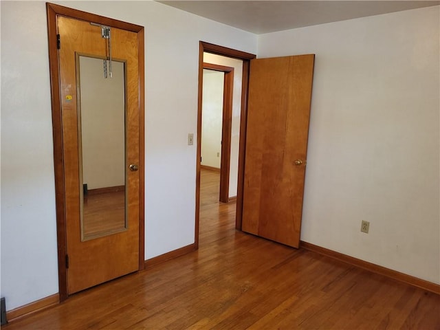 unfurnished bedroom with hardwood / wood-style flooring