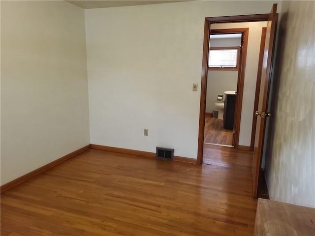 unfurnished room featuring wood-type flooring