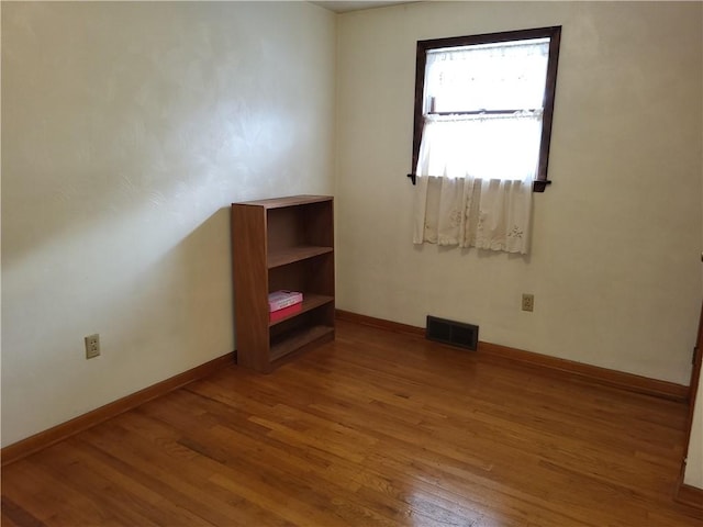 empty room with hardwood / wood-style floors