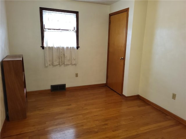 empty room with light hardwood / wood-style floors