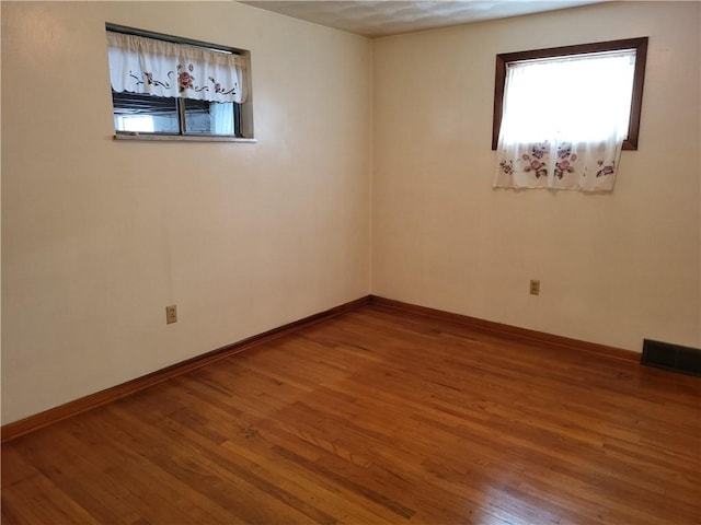 spare room with hardwood / wood-style flooring