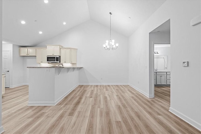 1261 Sandy Ridge Dr, Buffalo Twp, PA 16055 - kitchen featuring a notable chandelier, kitchen peninsula, hanging light fixtures, and light hardwood / wood-style flooring
