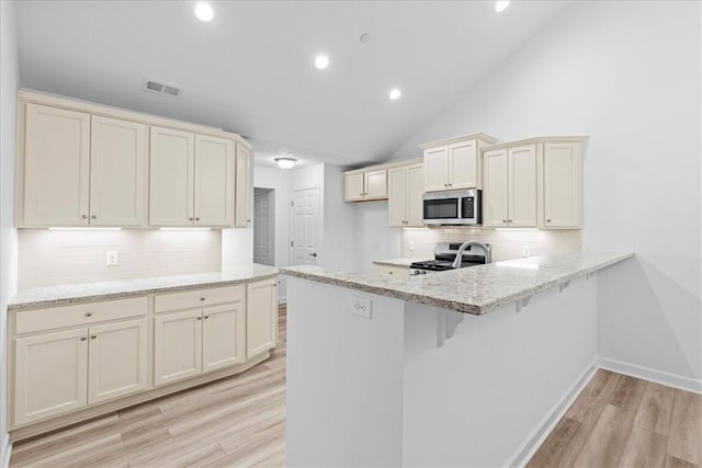 1261 Sandy Ridge Dr, Buffalo Twp, PA 16055 - kitchen with tasteful backsplash, appliances with stainless steel finishes, light hardwood / wood-style floors, and cream cabinetry